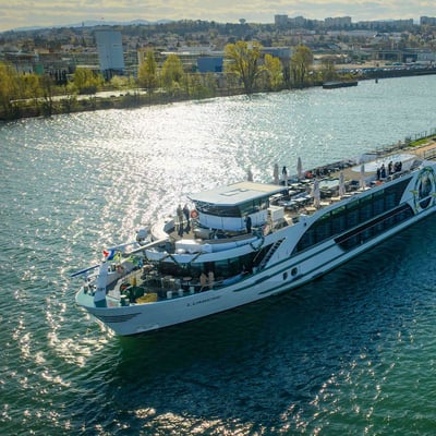 Tauck's new vessel, ms Lumiere, sailing along a river