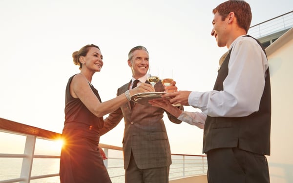 Couple served drinks on board Seabourn