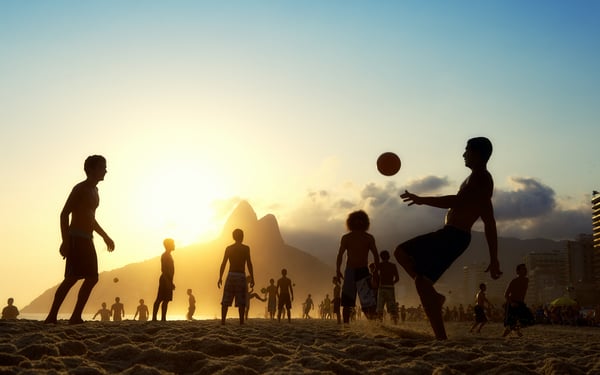 Playing football on Ipanema Beach, Rio de Janeiro