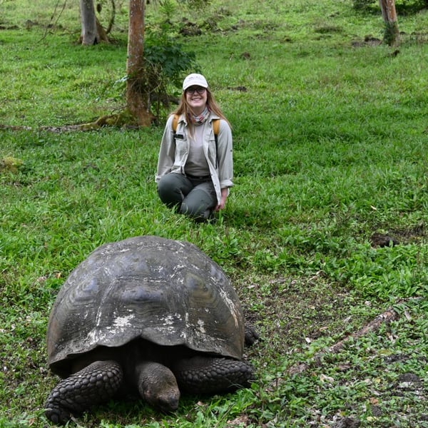Louise and a giant tortoise in the Galapagos Islands