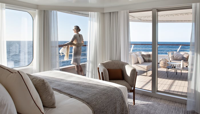 traveller on balcony ponant ship LE BOUGAINVILLE 
