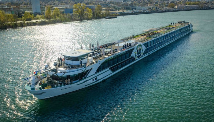 Tauck's new vessel, ms Lumiere, sailing along a river