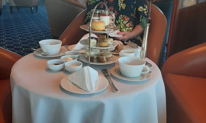 Cathy enjoying afternoon tea on Seabourn Ovation