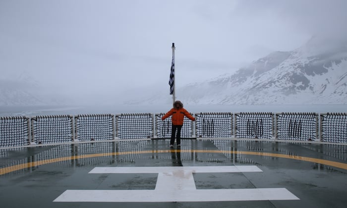 Claire on the helipad of Le Commandant Charcot in Ammasalik fjord in Greenland