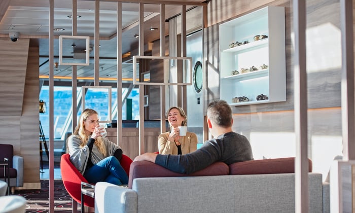 Family in the Explorer Lounge on MS Fridtjof Nansen on a Hurtigruten expedition cruise