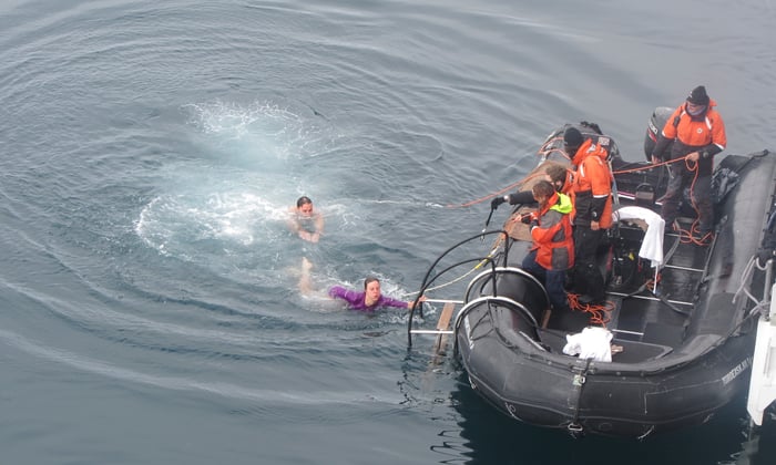 Alex taking the polar plunge in Antarctica