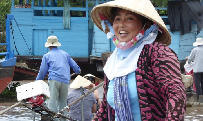 Happy lady on the Mekong in Cai Be, Vietnam