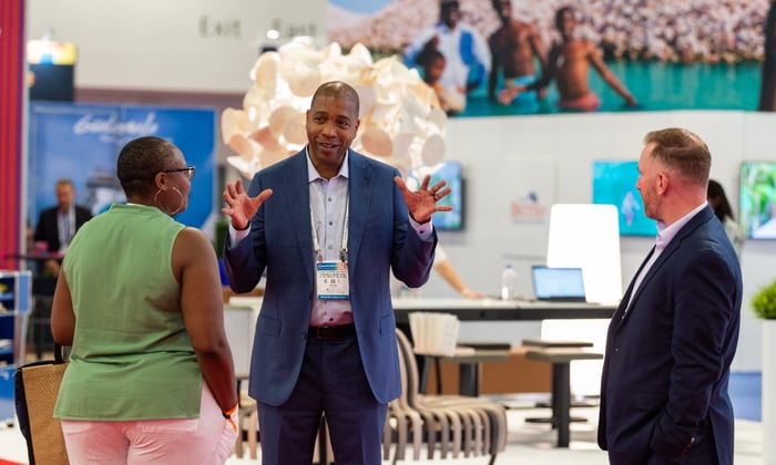 Exhibitor speaking to guests at Seatrade Cruise Global in Miami 2022