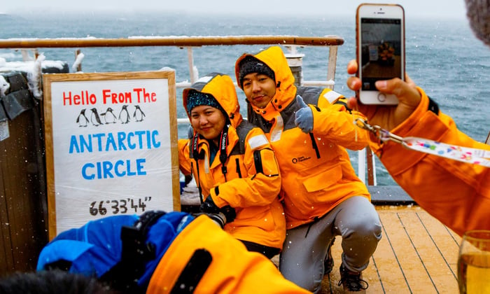 Quark Expeditions - iPhone photo of couple crossing Antarctic Circle
