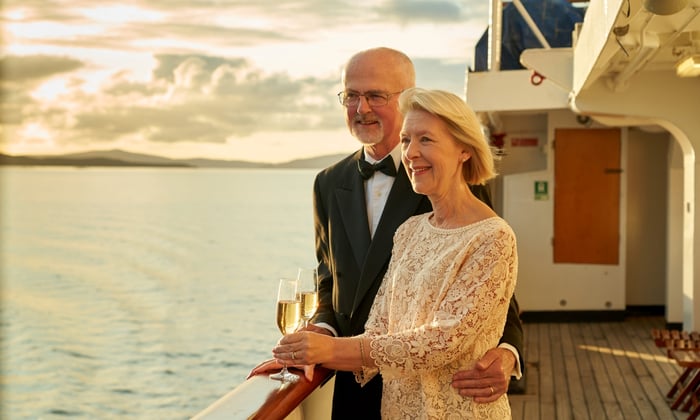 Guests in formal wear on the boat Deck of Hebridean Princess