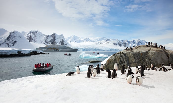 Zodiacs approaching Gentoo penguins in the Antarctica Peninsula