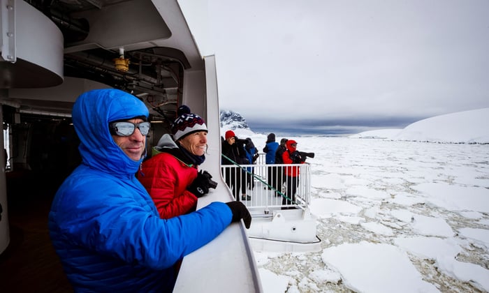 Guests on hydraulic viewing platforms aboard Greg Mortimer