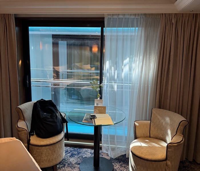Living room in French Balcony Suite on Tauck River Cruises' MS Inspire