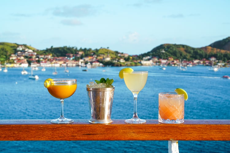 Enjoying cocktails on a Seabourn cruise in the Caribbean, a destination that features in our 2022 cruise trends