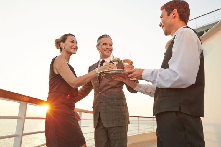 Couple served drinks on board Seabourn