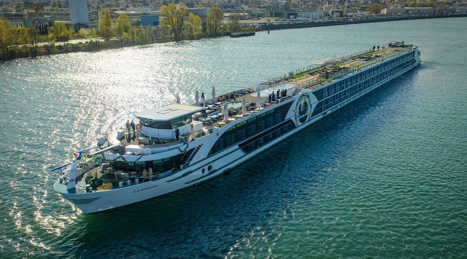 Tauck's new vessel, ms Lumiere, sailing along a river