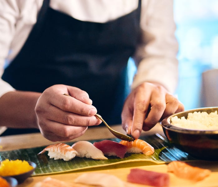 Chef preparing sushi on Evrima, The Ritz-Carlton Yacht Collection